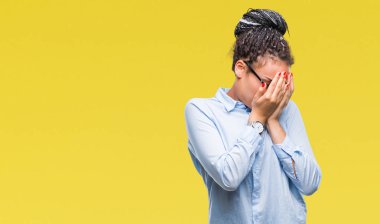 Üzgün ifade yüz eller ile ağlayarak süre kapsayan ile izole arka plan üzerinde gözlük takan genç örgülü saç Afro-Amerikan iş kız. Depresyon kavramı.