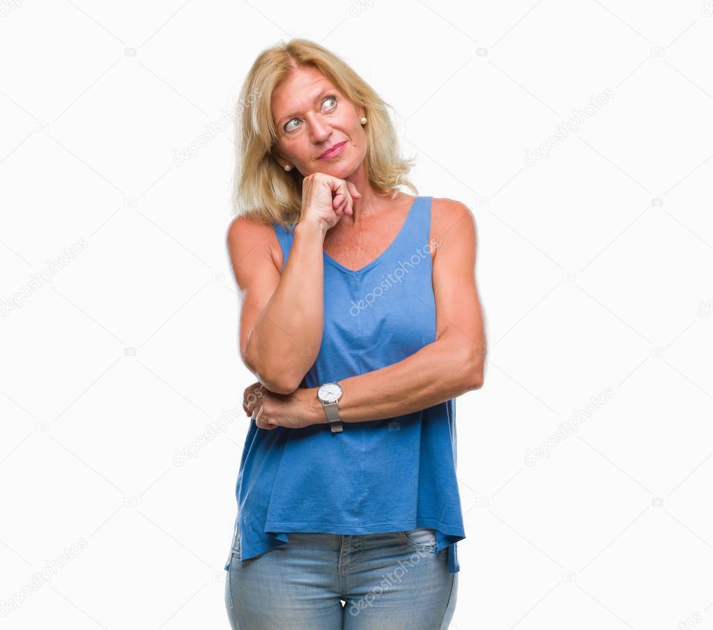 Middle age blonde woman over isolated background with hand on chin thinking about question, pensive expression. Smiling with thoughtful face. Doubt concept.