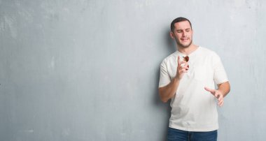 Güneş gözlüğü takıyor gri grunge duvarın üzerinden beyaz delikanlı tiksinti ifadesi, memnun ve korkulu tiksinti yüz yapıyorsun çünkü nefret tepki. Elleriyle kaldırdı. Sinir bozucu kavramı.