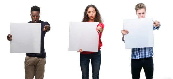 Composition Young People Holding Blank Banner Isolated Background Pointing Finger — Stock Photo, Image