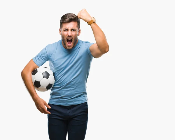 Jovem Homem Bonito Segurando Bola Futebol Sobre Fundo Isolado Irritado — Fotografia de Stock