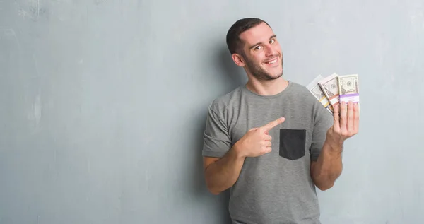 Young Caucasian Man Grey Grunge Wall Holding Bunch Money Very — Stock Photo, Image