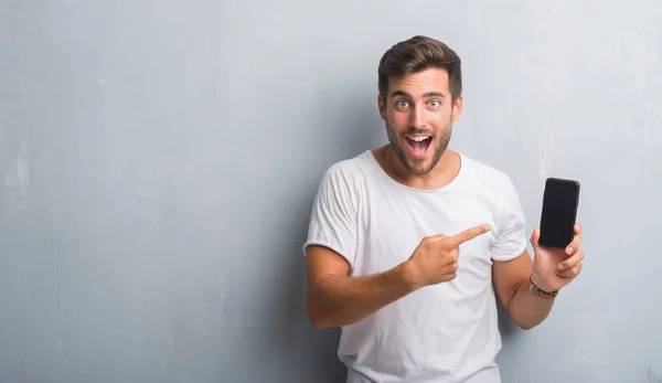 Handsome Young Man Grey Grunge Wall Speaking Phone Very Happy — Stock Photo, Image