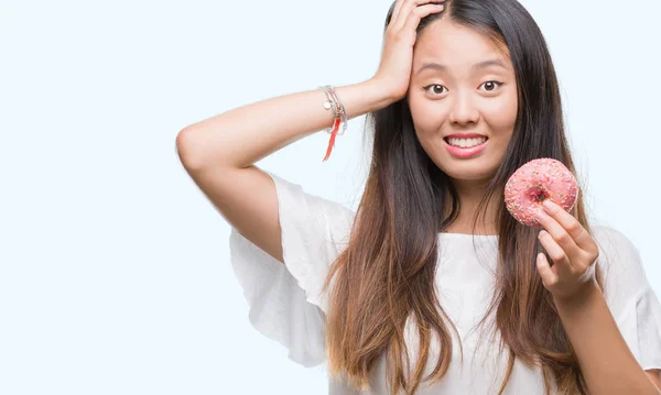 Young Asian Woman Eating Donut Isolated Background Stressed Hand Head — Stock Photo, Image