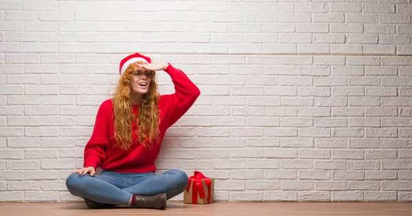 Junge Rothaarige Frau Sitzt Über Backsteinmauer Mit Weihnachtsmütze Sehr Glücklich — Stockfoto