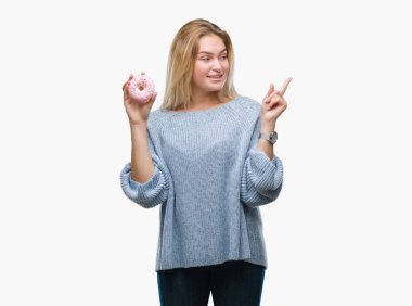 İzole arka tarafına el ve parmak ile işaret çok mutlu üzerinde tatlı çörek yiyen genç kafkas kadın