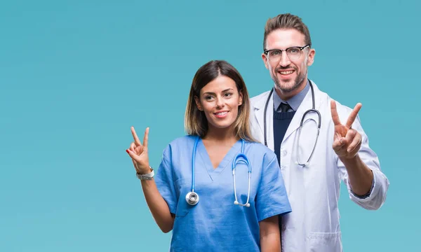 Young Couple Doctor Surgeon Isolated Background Smiling Happy Face Winking — Stock Photo, Image