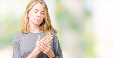 Elleri ve parmakları, artrit inflamasyon izole arka plan acı acı üzerinde büyük boy rahat t-shirt giyen güzel genç kadın