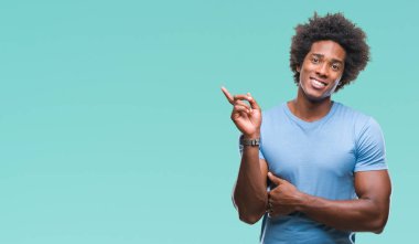 Kameraya bakarak yan el ve parmak ile işaret Afro Amerikalı adam yüzünde kocaman bir gülümseme ile izole arka plan üzerinde.