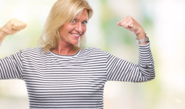 Orta yaş sarışın kadın kol kasları gururlu gülümseyen gösterilen izole arka plan yüzünden. Fitness kavramı.