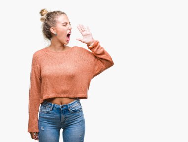 Güzel sarışın genç kadın bağırarak ve ağzı üzerinde el ile yan için çığlık izole arka plan üzerinde. İletişim kavramı.