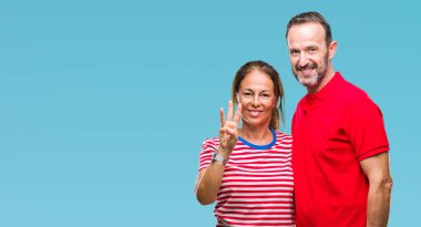 Orta yaş İspanyol çift gösterilen ve parmakları ile işaret izole arka plan üzerinde aşık ise kendinden emin ve mutlu gülümseyerek üçüncüsü.