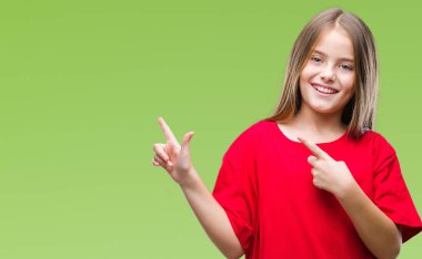 Genç güzel kız gülümseyerek ve iki elleri ve parmakları ile tarafına işaret kamera bakarak izole arka plan üzerinde.