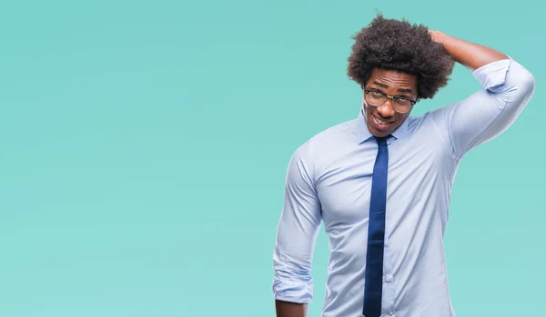 Afro american business man wearing glasses over isolated background confuse and wonder about question. Uncertain with doubt, thinking with hand on head. Pensive concept.