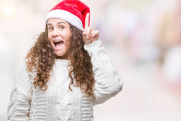 Young Brunette Girl Wearing Christmas Hat Isolated Background Pointing Finger — Stock Photo, Image