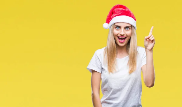 分離背景成功したアイデアと指を上向きに若い金髪美人クリスマス帽子 終了したと満足しています ナンバーワン — ストック写真