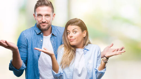 Young Couple Love Isolated Background Clueless Confused Expression Arms Hands — Stock Photo, Image
