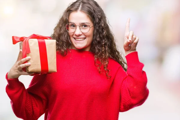 Young Brunette Girl Holding Gift Isolated Background Surprised Idea Question — Stock Photo, Image