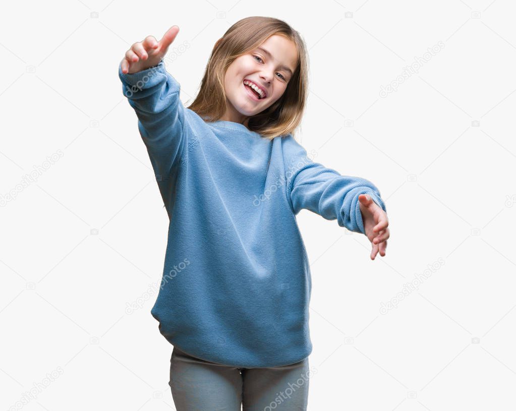 Young beautiful girl wearing winter sweater over isolated background looking at the camera smiling with open arms for hug. Cheerful expression embracing happiness.