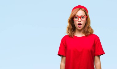 Genç güzel kadın izole arka plan korkuyor ve sürpriz ifade ile şok yüzünden korku ve yüz heyecanlı.