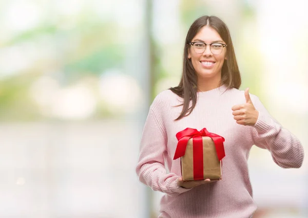 Young Hispanic Woman Holding Gift Happy Big Smile Doing Sign — Stock Photo, Image