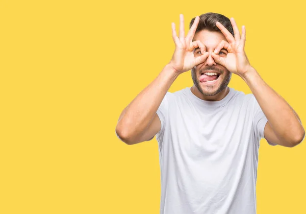 Young Handsome Man Isolated Background Doing Gesture Binoculars Sticking Tongue — Stock Photo, Image