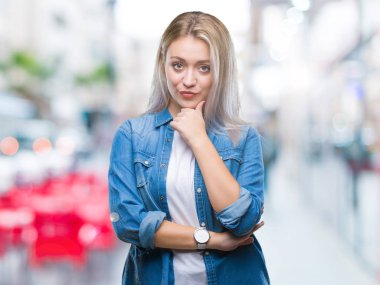 Genç Sarışın kadın yüzünden izole arka plan emin çapraz kollar ve çeneme kaldırdı el ile gülümseme ile kameraya bakıyor. Pozitif düşünce.