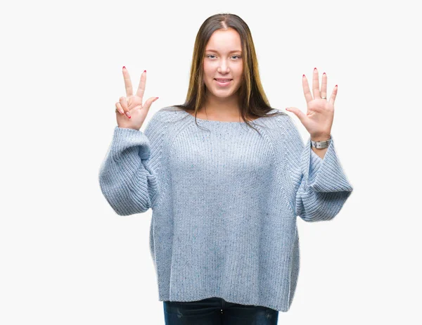 年轻美丽的白人妇女穿着冬季毛衣在孤立的背景显示和指向与手指数字八同时微笑自信和快乐 — 图库照片