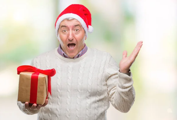 Bonito Homem Sênior Vestindo Chapéu Natal Segurando Presente Sobre Fundo — Fotografia de Stock