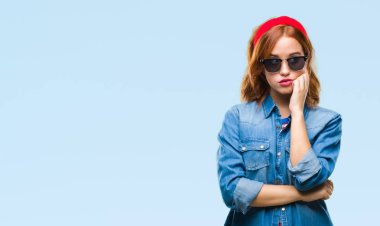 İzole arka plan seyir yorgun ve çapraz kolları olan depresyon sorunları ile sıkılmış düşünme güneş gözlüğü takmış genç güzel kadın.