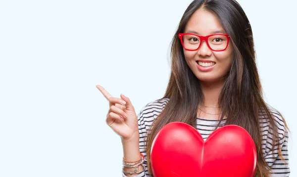 Junge Verliebte Asiatin Hält Leseherz Über Isoliertem Hintergrund Und Zeigt — Stockfoto