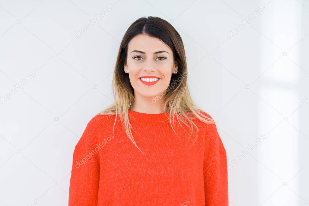 Young woman wearing casual red sweater over isolated background with a happy and cool smile on face. Lucky person.