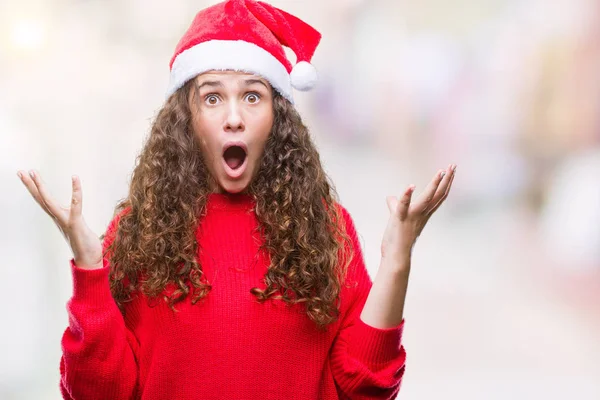 上クリスマスの帽子を着ている若いブルネットの少女は 背景を祝う怒って叫んで調達とクローズの目が興奮して腕を成功のために狂気を分離しました 勝者の概念 — ストック写真