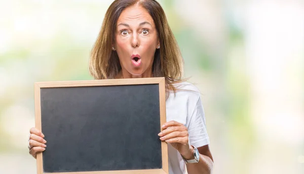 Middle Age Hispanic Woman Holding Blackboard Isolated Background Scared Shock — Stock Photo, Image