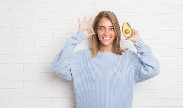 Beautiful Young Woman White Brick Wall Eating Fresh Avocado Doing — Stock Photo, Image
