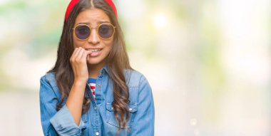 Tırnak ısırma dudaklarından eller genç güzel Arap kadın stresli ve gergin ile izole arka plan üzerinde güneş gözlüğü takıyor. Anksiyete sorunu.