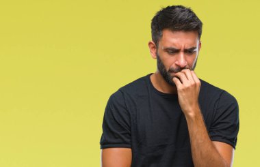 Yetişkin İspanyol adam stresli ve gergin ile izole arka plan üzerinde tırnak ısırma dudaklarından eller. Anksiyete sorunu.