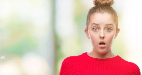 Young Blonde Woman Wearing Bun Red Sweater Afraid Shocked Surprise — Stock Photo, Image