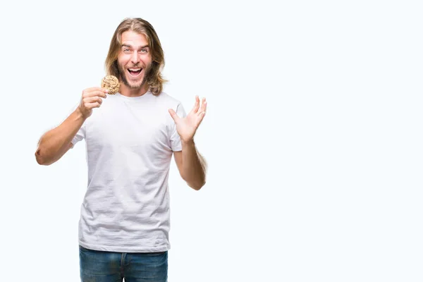 Young Handsome Man Long Hair Eating Chocolate Cooky Isolated Background — Stock Photo, Image