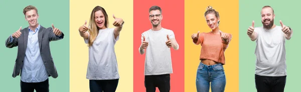 集体的人 妇女和男人在五颜六色的孤立背景下赞成用手做积极的手势 竖起大拇指微笑 为成功而高兴 看着镜头 赢家的手势 — 图库照片