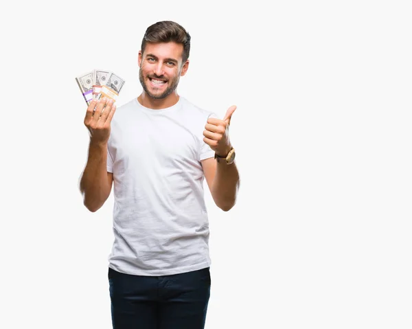 Joven Hombre Guapo Sosteniendo Pila Dólares Sobre Fondo Aislado Feliz —  Fotos de Stock