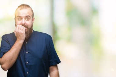 Genç beyaz hipster adam stresli ve gergin elle çivi ısırma ağzına bakarak izole arka plan üzerinde. Anksiyete sorunu.