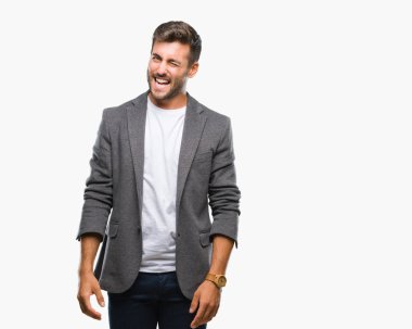 Genç yakışıklı iş adamı seksi bir ifadeyle, neşeli ve mutlu yüzünü kameraya bakarak göz kırpıyor izole arka plan üzerinde.