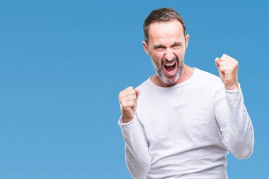 Gülümseyen ve başarı için çığlık çok mutlu ve heyecanlı kaldırdı, silah ile kazanan jest yapıyor izole arka plan üzerinde beyaz t-shirt giyen orta yaş ağarmış komuta sizde. Kutlama kavramı.