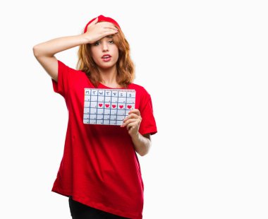 İzole arka plan baş, el ile vurguladı adet takvim tutan genç güzel kadın şok utanç ve sürpriz suratla, öfkeli ve sinirli. Korku ve hata için üzgün.