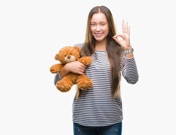 Young Caucasian Woman Holding Teddy Bear Isolated Background Doing Sign — Stock Photo, Image