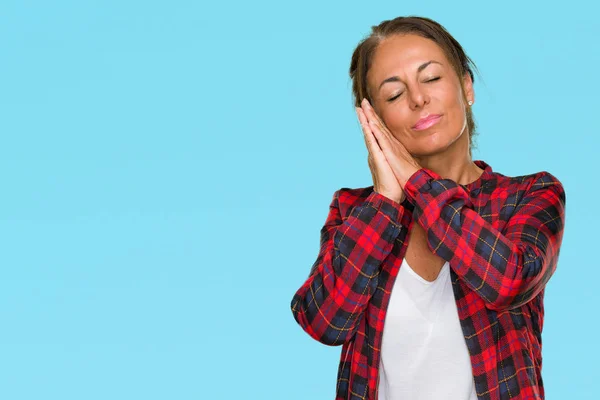 Middle age adult woman wearing casual jacket over isolated background sleeping tired dreaming and posing with hands together while smiling with closed eyes.