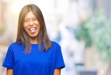 Genç Asyalı kadın dilini izole arka plan üzerinde out komik ifade ile mutlu. Duygu kavramı.