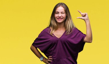 Genç güzel sarışın zarif kadın izole arka plan gülümseyen ve süre seyir ve kamera boyutu işaret parmaklarıyla yapıyor el ile kendine güvenen el hareketi yüzünden. Ölçü kavramı.