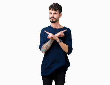 Yakışıklı delikanlı izole arka plan üzerinde işaretleme için her iki parmak, farklı yönde ile katılmıyorum